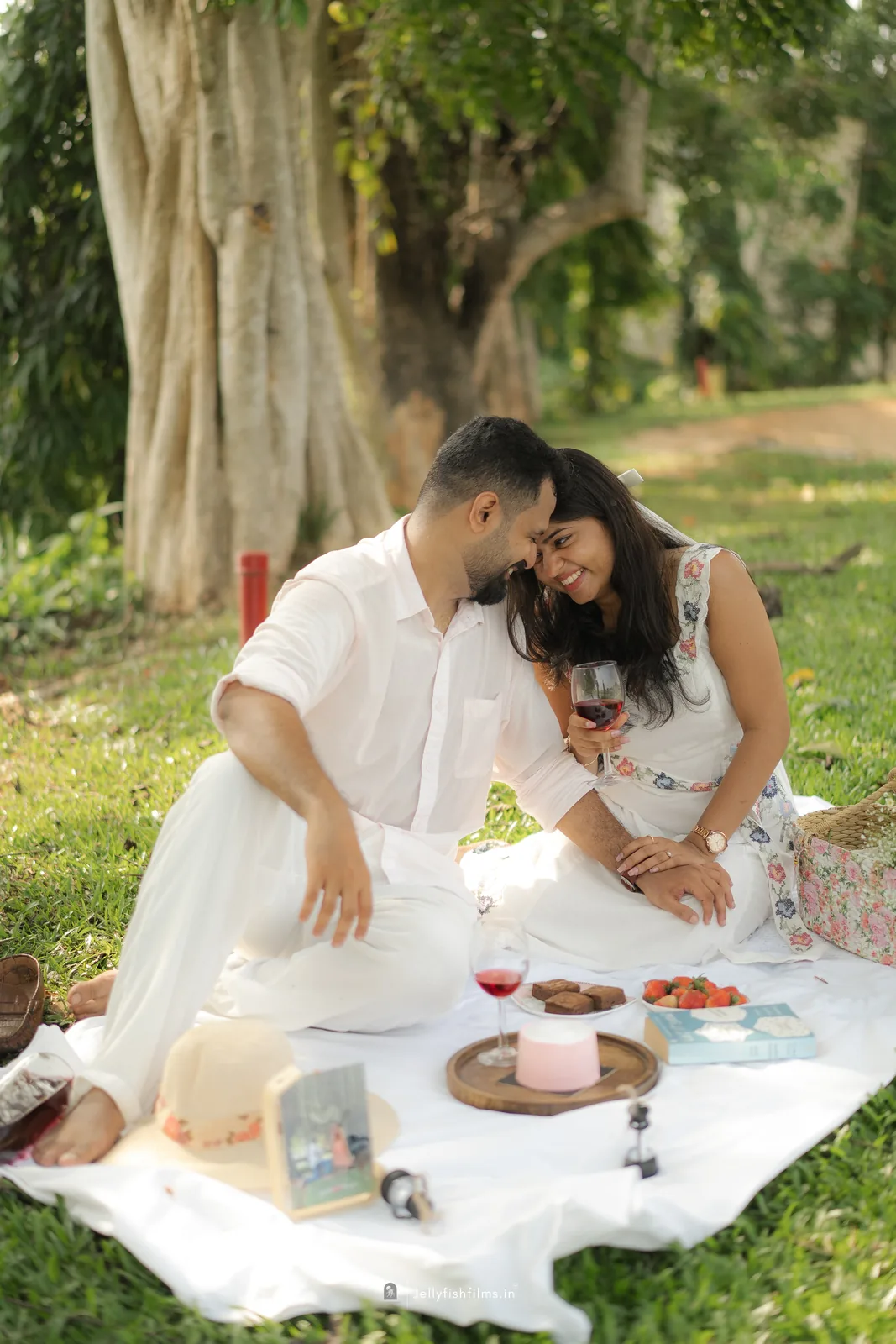Aaron and Tinu seated together at a picnic
